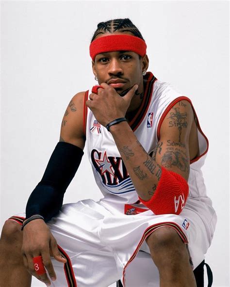 A Man Sitting On Top Of A Basketball Court Wearing A Red Headband And