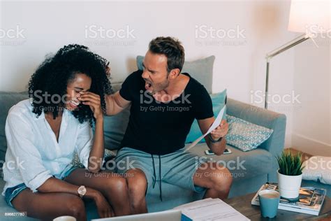 Young Interracial Couple In The Couch Stressed With Financial Problems