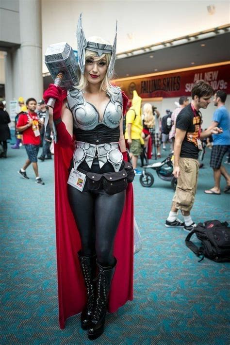A Woman Dressed As Thor From The Movie Thor Is Standing In An Airport