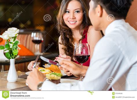Chinese Couple Having Romantic Dinner In Fancy Restaurant Royalty Free