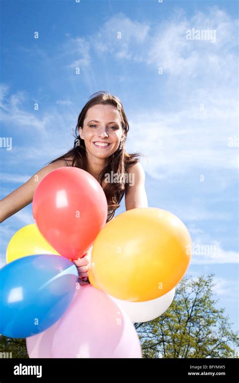Portrait Of Young Woman Holding Colourful Balloons Stock Photo Alamy