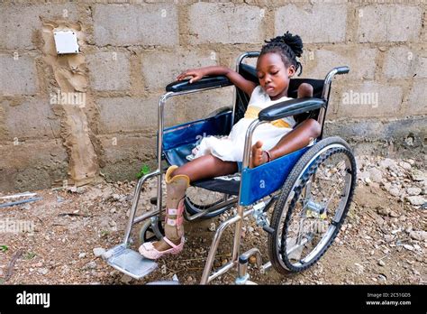 Physically Handicapped Orphan Precious 8 Sits In Her Wheelchair At