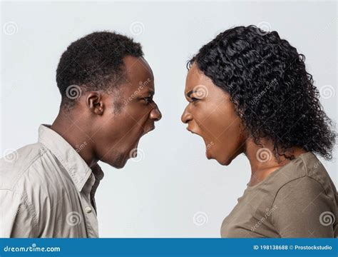 Black Man And Woman Fighting Over Grey Background Stock Photo Image