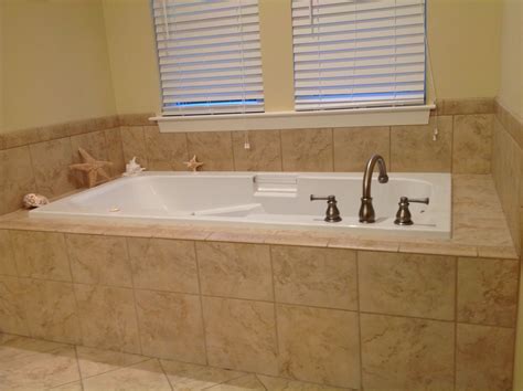 A whirlpool tub utilises water jets that are placed on the sides and the base of the tub that have an intense massaging effect on the body. Deep jetted tub with tile surround. | Tub remodel ...