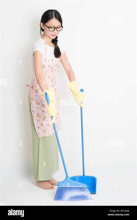 Young Asian Woman Sweeping Floor With Broom And Dustpan Cleaning