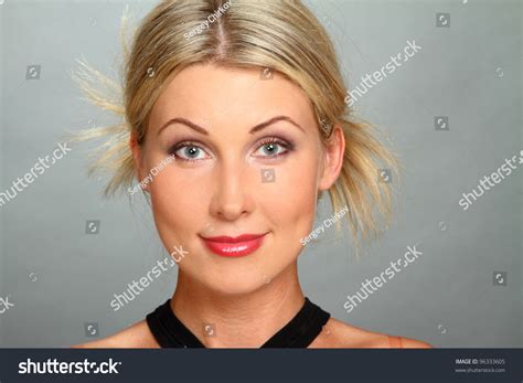 Portrait Of The Beautiful Girl Blonde With Gray Eyes Looks In The