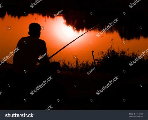 Silhouette Of A Man Fishing In A Sunset Stock Photo 11816188 Shutterstock