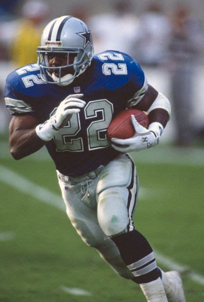 Running Back Emmitt Smith Of The Dallas Cowboys Carries The Ball During