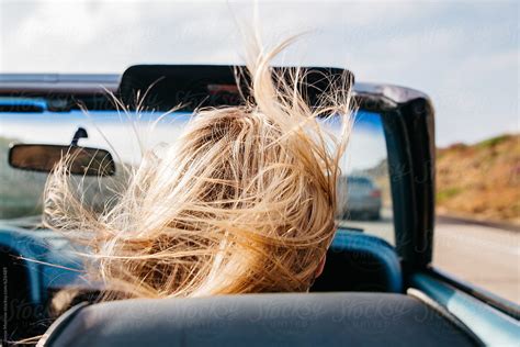 Young Blonde Female Hair Blowing In Wind While Riding In Convertible