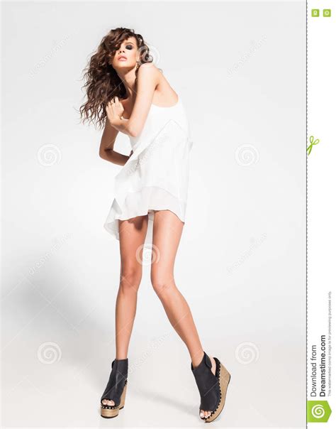 Full Body Of Beautiful Woman Model Posing In White Dress In The Studio
