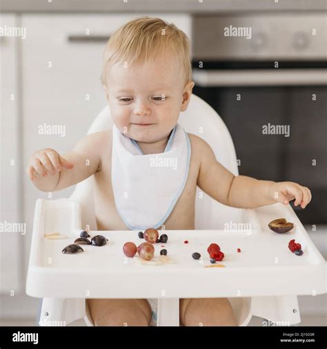Smiley Cute Baby Eating Alone Stock Photo Alamy