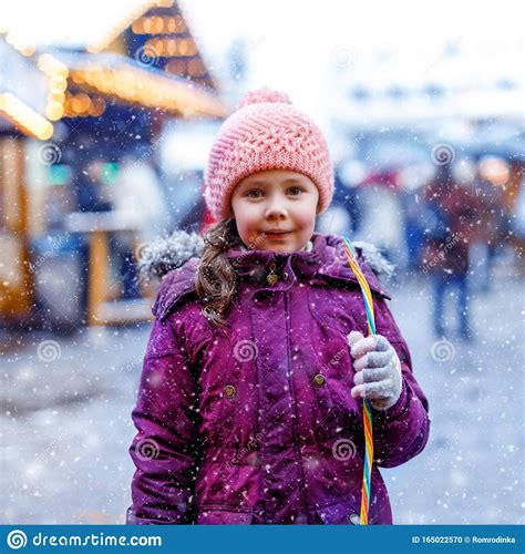 Little Cute Kid Girl Having Fun On Traditional German Christmas Market