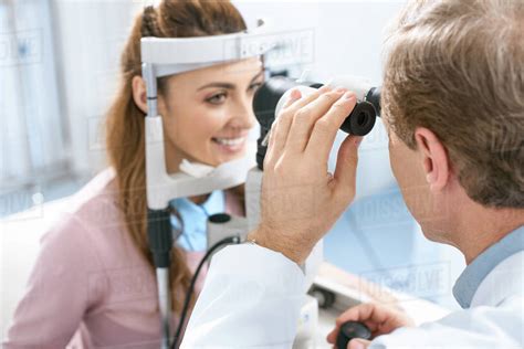 Oculist Examining Patient Vision With Slit Lamp In Clinic Stock Photo
