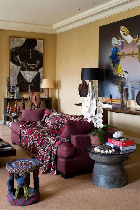 A Living Room Filled With Furniture And Paintings On The Wall