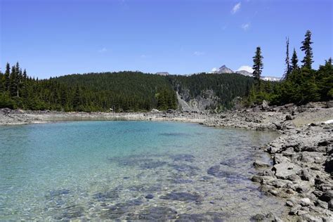 Lake With Clear Crisp Water Surrounded With Mountaineous Scenery Stock
