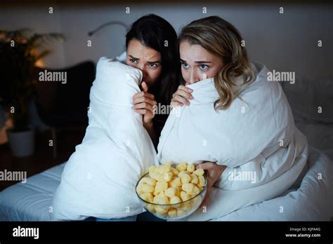 Scared Girls Hiding In Blanket While Watching Horrors On Tv At Night