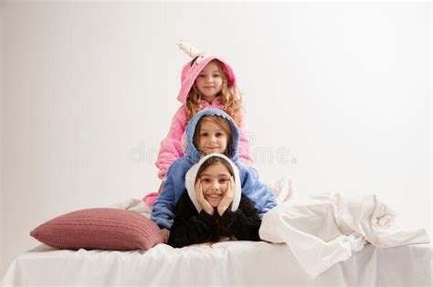 Children In Soft Warm Pajamas Having Party Colored Bright Playing At