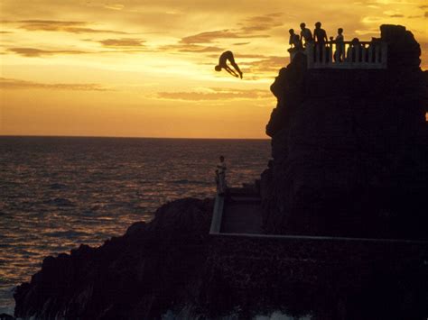 Cliff Divers Mazatlan Mexico Photograph By We Garrett A Daring Diver Times His Plunge With