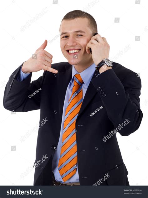 Young Businessman Using A Call Me Gesture And A Phone Stock Photo