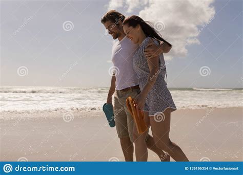 Romantic Happy Young Couple Walking With Beach Footwear On Beach Stock