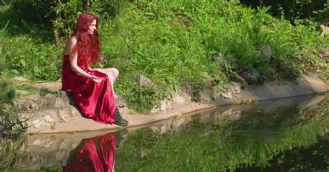 Redhead Woman Sitting By A Lake By Atwstock On Envato Elements