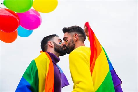Young Gay Couple Kissing On Parade Free Photo