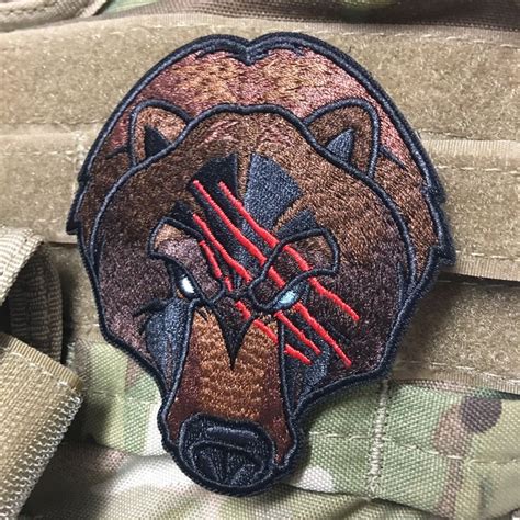 A Patch On The Back Of A Backpack With A Bears Head Painted On It