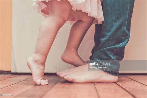 Close Up Image Of Daughter Standing On Mothers Feet Photo Getty Images
