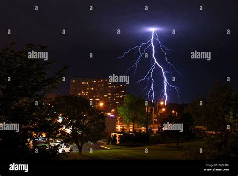 Lightning Bolt Strikes The Ground In An Urban Environment Stock Photo