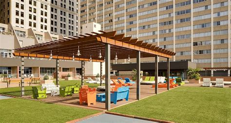 Modern Aluminum Shade Structure With Lighting Over Rooftop Seating Area