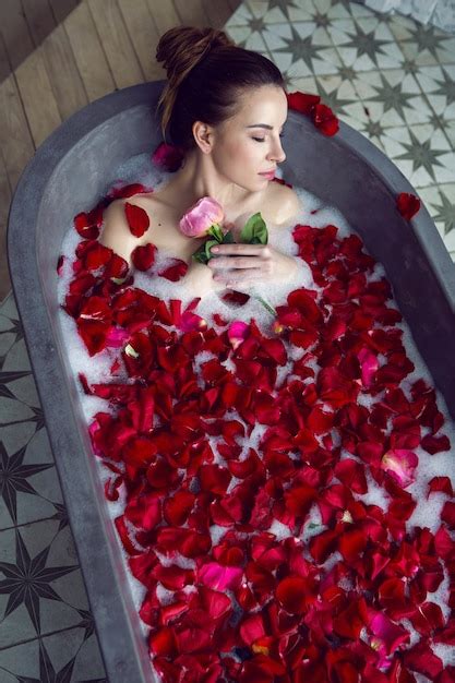 Premium Photo Beautiful Woman Lying In A Stone Bath With Rose Petals