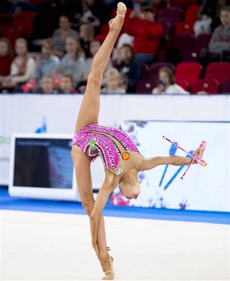 A Woman Doing A Handstand In Front Of An Audience