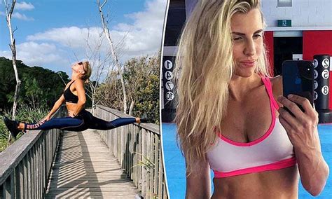 tiffiny hall flaunts her impressive flexibility as she does the splits on a boardwalk