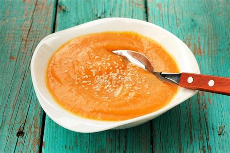 Homemade Pumpkin Soup Puree With Sesame Seeds On Turquoise Table Stock