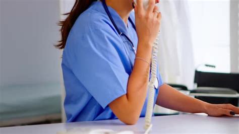 Medical Receptionist Answering Phone Calls From Patient Stock Footage