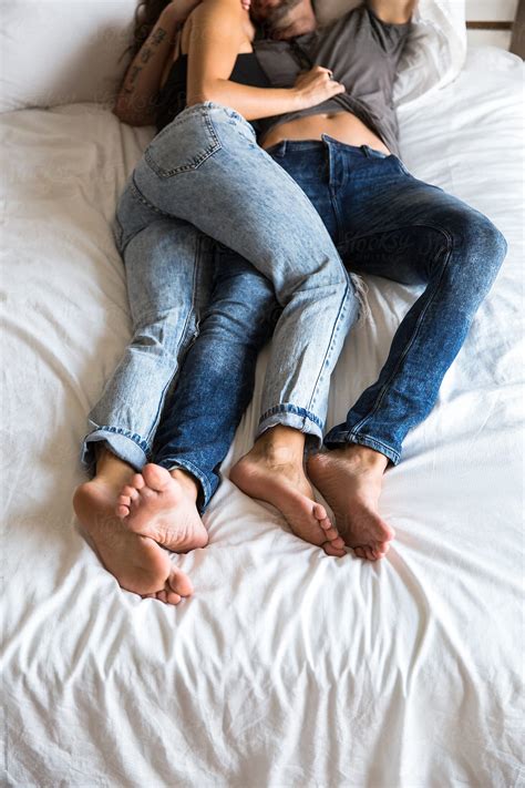 Couple In Bed Wearing Jeans Del Colaborador De Stocksy Jovo