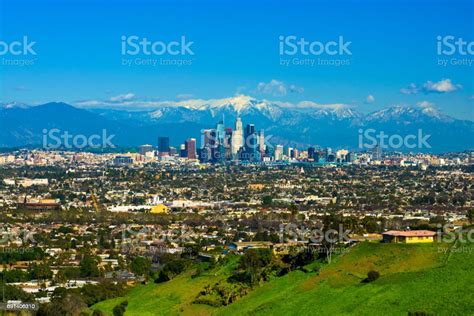 Los Angeles Skyline With Snowcapped Mountains From A Hill Stock Photo