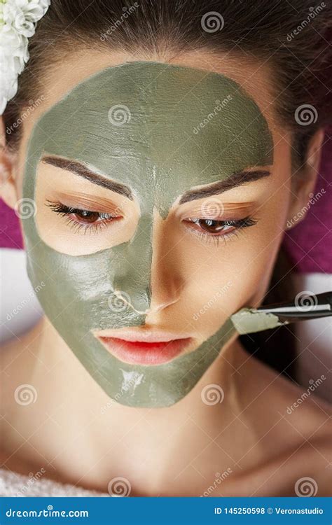 Woman With Clay Facial Mask In Beauty Spa Skincare Beauty Concept