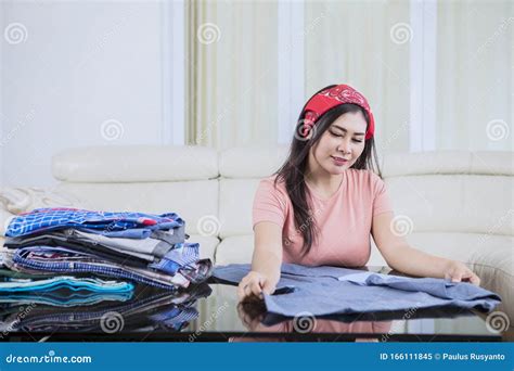 beautiful asian woman folding clothes stock image image of house headwear 166111845