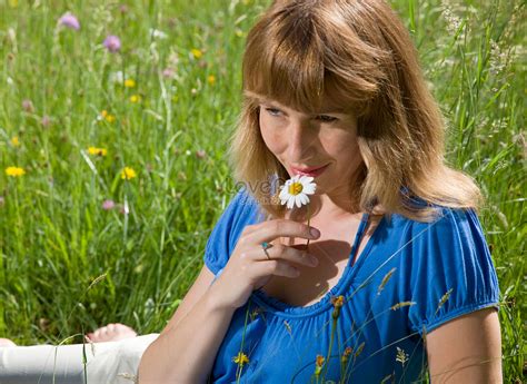 Woman Lying On The Grass Smelling Flowers Picture And Hd Photos Free