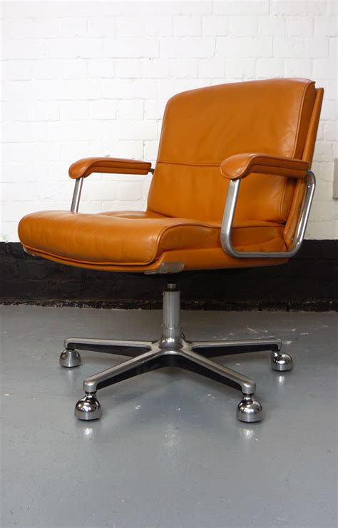 Iron swivel in polished steel ups the sleek factor. Good Stylish 1970s Vintage Tan Leather Office Executive ...