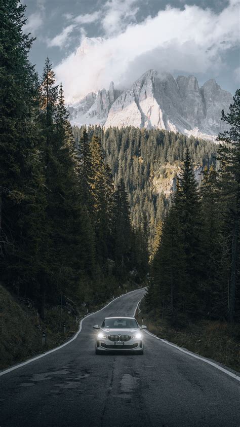 Download Wallpaper 1350x2400 Car Road Mountains Forest Nature