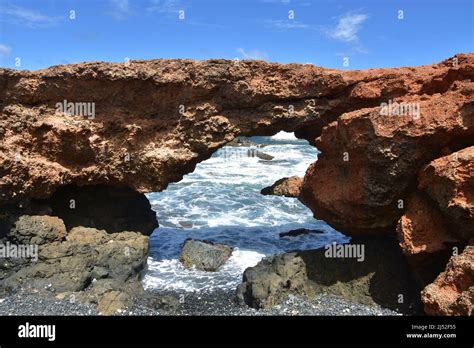 Scenic Black Stone Beach Natural Lava Rock Bridge In Aruba Stock Photo