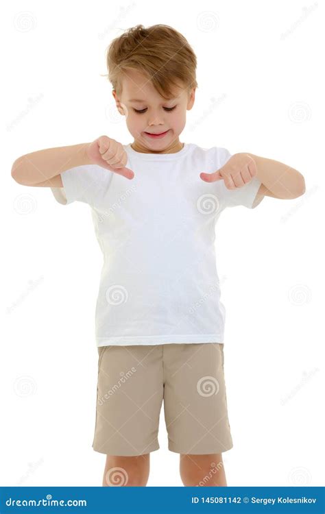 A Little Boy In A Pure White T Shirt Points His Fingers At Her Stock