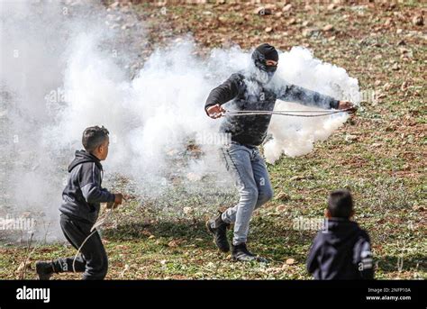 Nablus Palestine 17th Feb 2023 A Palestinian Demonstrator Throws A Tear Gas Canister After