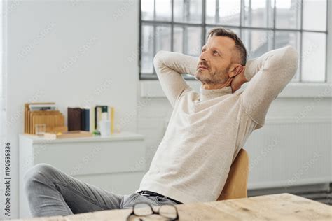 Man Leaning Back With Hands Behind His Head Stock Photo Adobe Stock