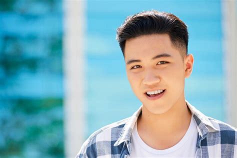 Premium Photo Portrait Of Handsome Asian Young Man Smiling At Camera