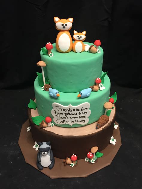 A Three Tiered Cake With Animals On It