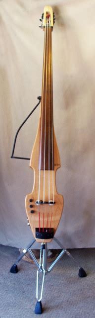 Electric upright basses are plugged into amplifiers and speakers, producing electrically amplified tones. Photo 1 of 2, Zeta Educator electric upright bass