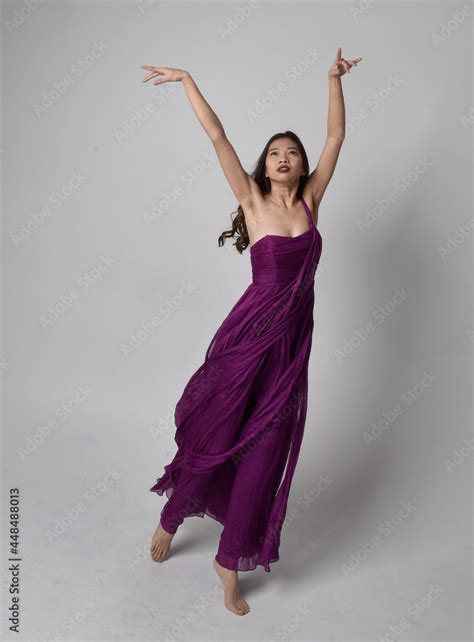 Full Length Portrait Of Pretty Brunette Asian Girl Wearing Purple